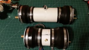 4" PVC primary and secondary cooling tanks with brass hose fittings, fill ports, and thermocouple gauges for the closed loop diffusion pump cooling system.